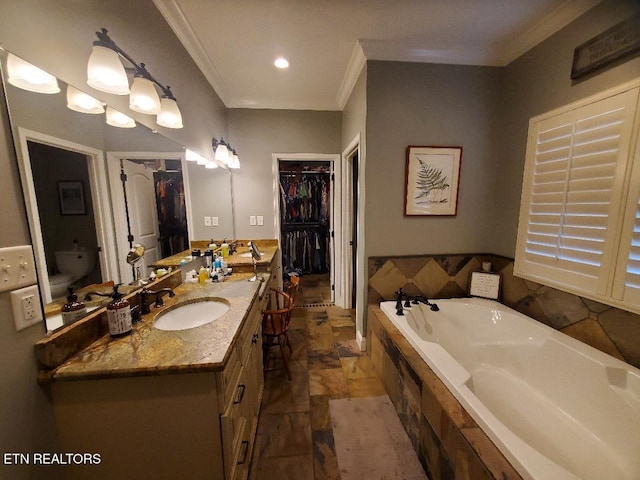 bathroom with vanity, a relaxing tiled tub, ornamental molding, and toilet