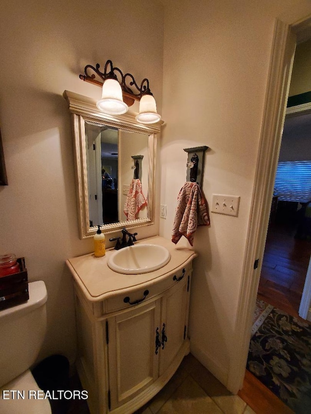 bathroom featuring vanity and toilet