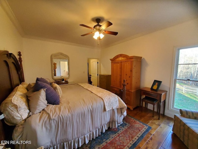 bedroom with crown molding, ceiling fan, and wood-type flooring