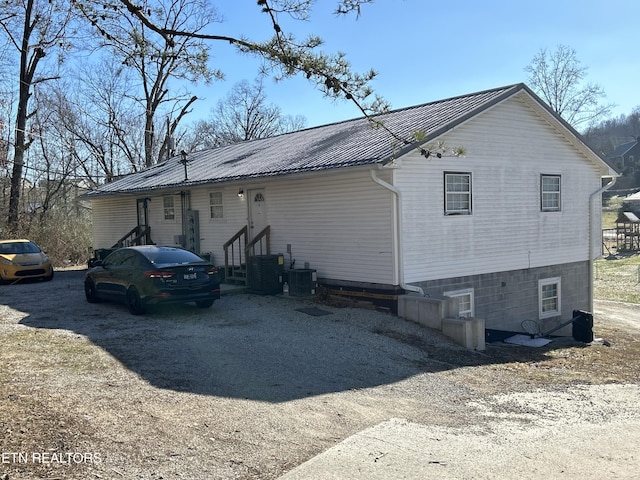 view of side of home with central AC unit