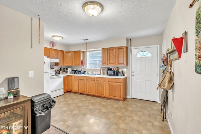 kitchen featuring hanging light fixtures, sink, a textured ceiling, and white appliances