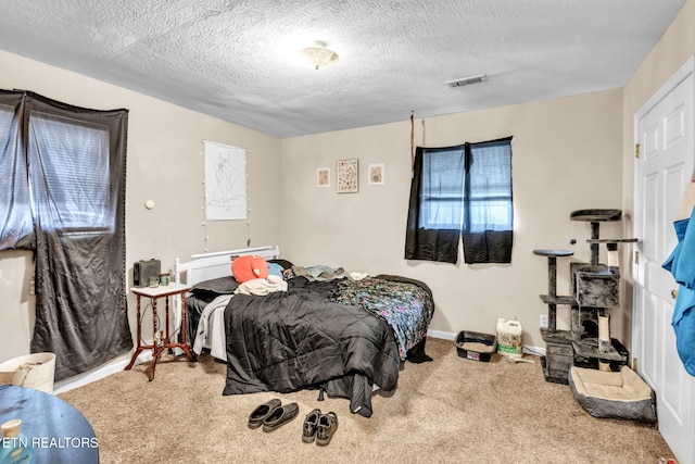 carpeted bedroom featuring a textured ceiling