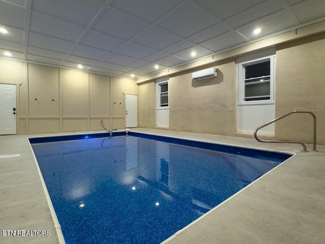 view of swimming pool featuring a wall unit AC