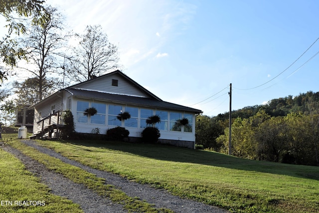 view of home's exterior with a yard