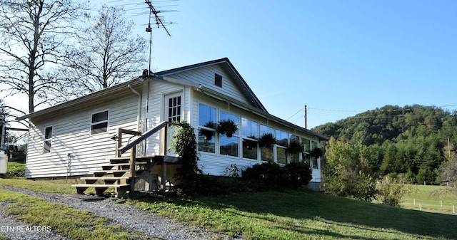 view of side of home with a lawn