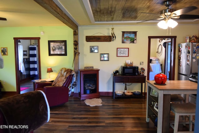 interior space featuring ceiling fan, dark wood-type flooring, and wood ceiling