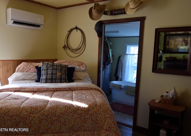 bedroom featuring hardwood / wood-style flooring, crown molding, a wall mounted air conditioner, and wood walls