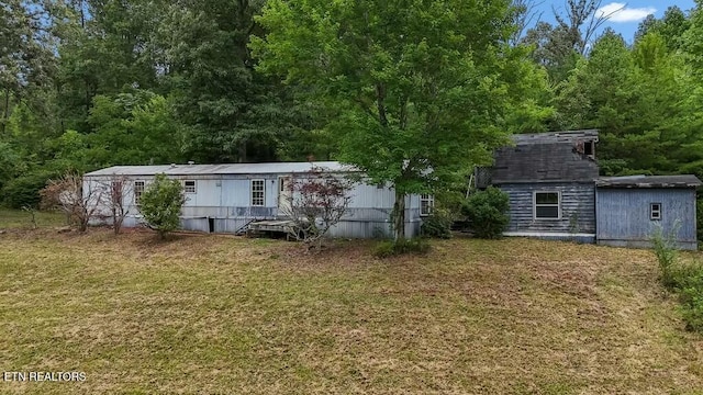 back of house with a lawn