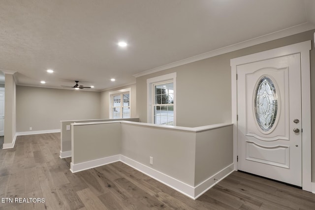 entryway featuring hardwood / wood-style floors and crown molding