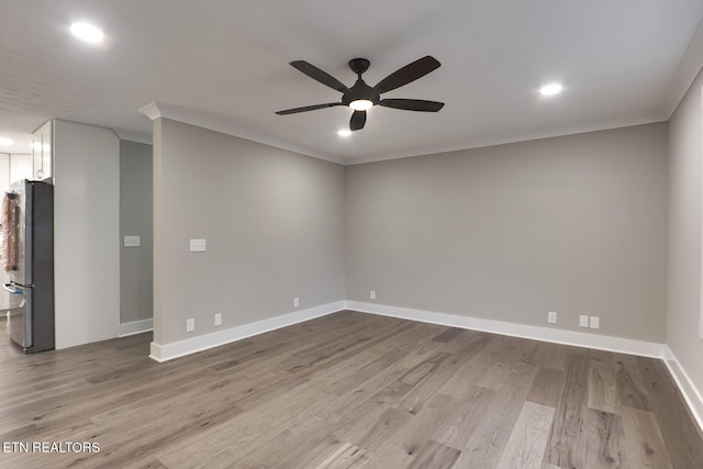 unfurnished room with crown molding, ceiling fan, and light hardwood / wood-style flooring