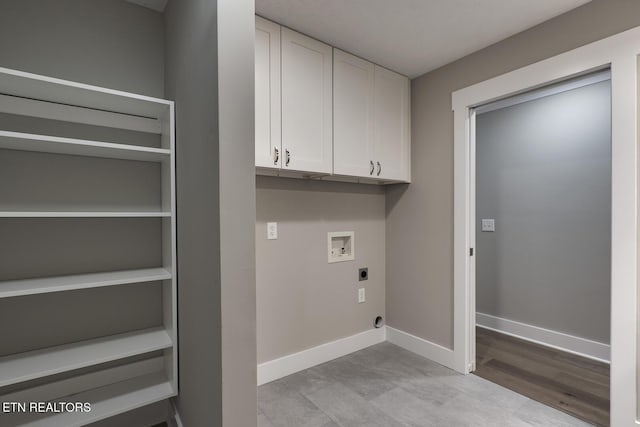 clothes washing area featuring hookup for a washing machine, electric dryer hookup, and cabinets