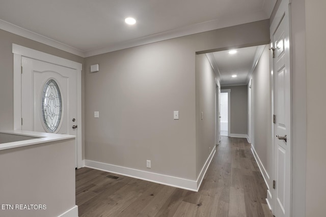 foyer with crown molding and hardwood / wood-style flooring