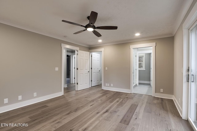 unfurnished bedroom featuring crown molding, ceiling fan, and light wood-type flooring