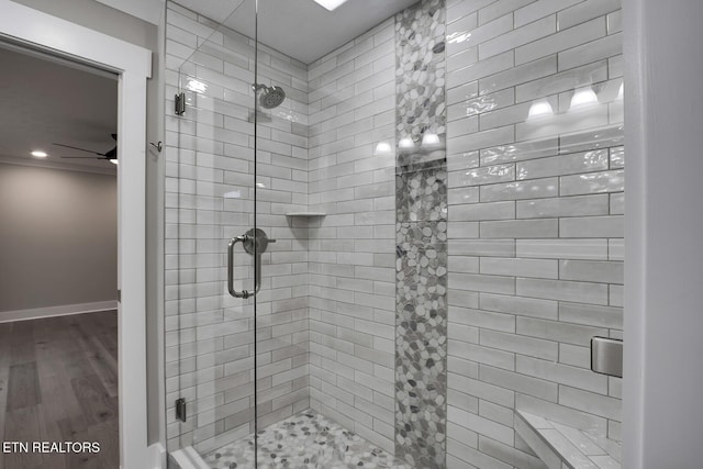 bathroom featuring walk in shower, ceiling fan, and hardwood / wood-style flooring