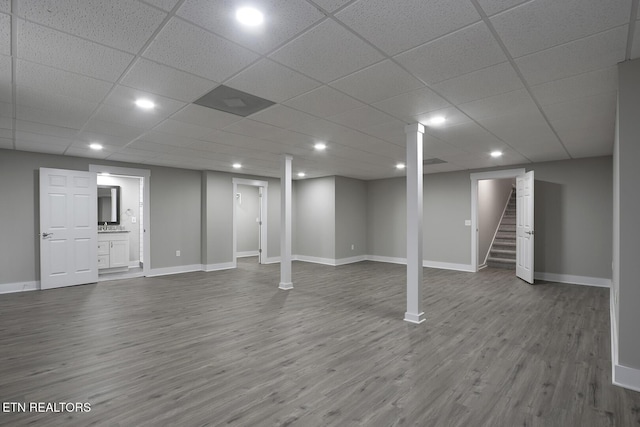 basement with hardwood / wood-style floors and a drop ceiling