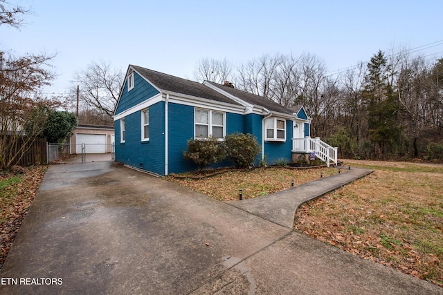 view of side of property featuring an outbuilding, a garage, and a lawn