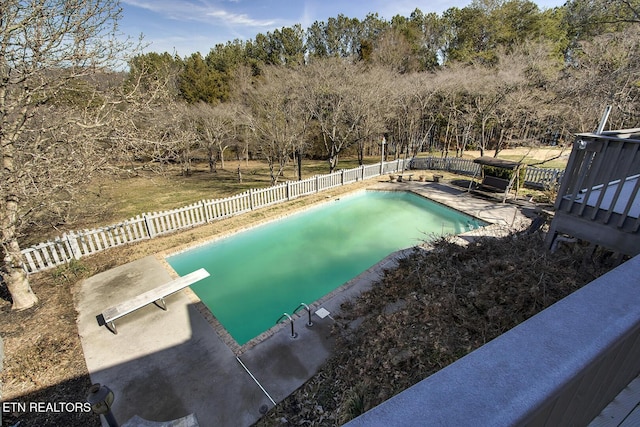 view of pool featuring a patio and a diving board