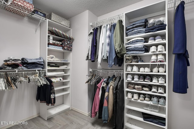 spacious closet with parquet floors