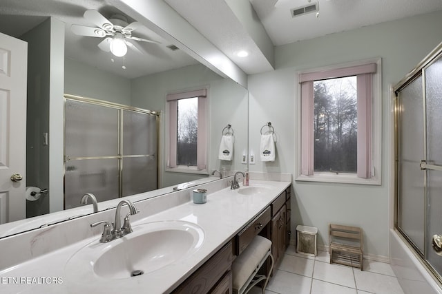 bathroom featuring ceiling fan, tile patterned floors, combined bath / shower with glass door, and vanity