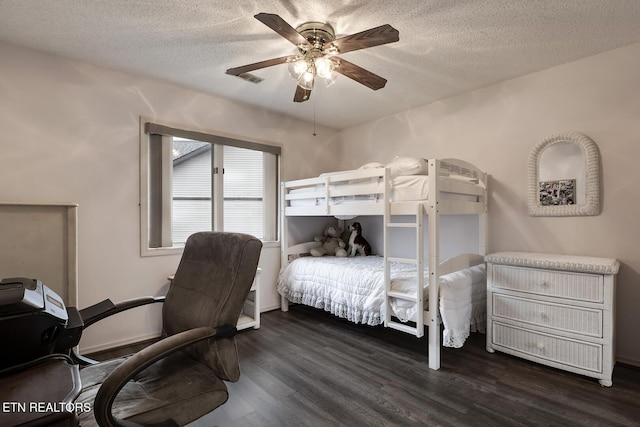 bedroom with ceiling fan, dark hardwood / wood-style floors, and a textured ceiling