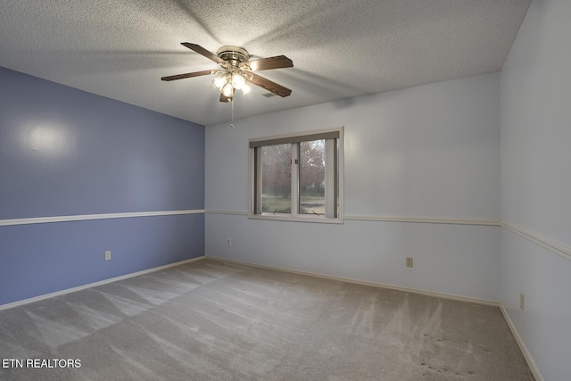 carpeted empty room featuring a textured ceiling and ceiling fan