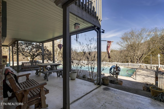 view of patio with a fenced in pool