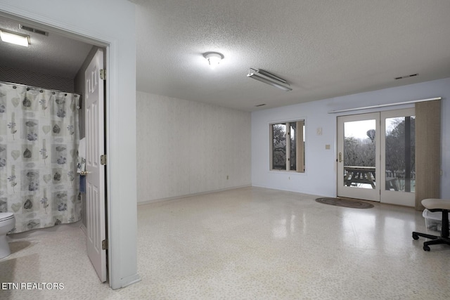 spare room with a textured ceiling