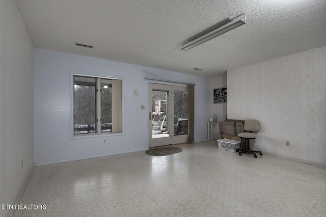 unfurnished room featuring a textured ceiling