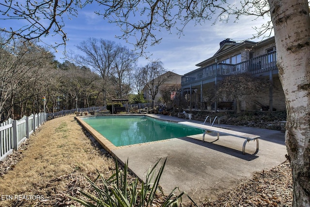 view of pool featuring a patio and a diving board