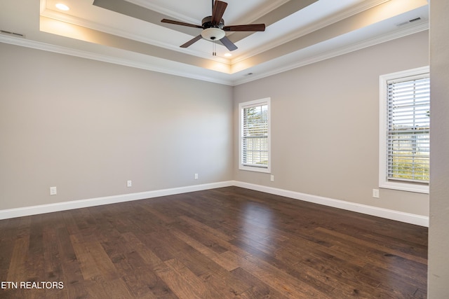 unfurnished room featuring ceiling fan, ornamental molding, dark hardwood / wood-style floors, and a raised ceiling