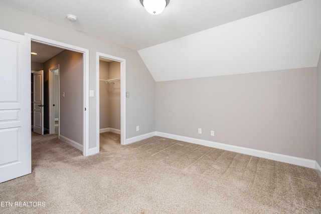 additional living space with lofted ceiling and carpet flooring