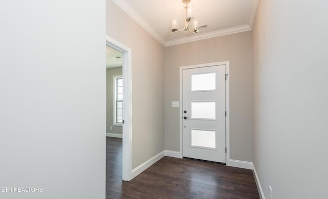 entryway featuring ornamental molding, dark hardwood / wood-style floors, and a chandelier