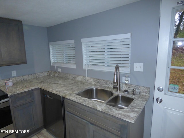 kitchen with sink, stainless steel electric range oven, dark brown cabinets, dishwasher, and light stone countertops