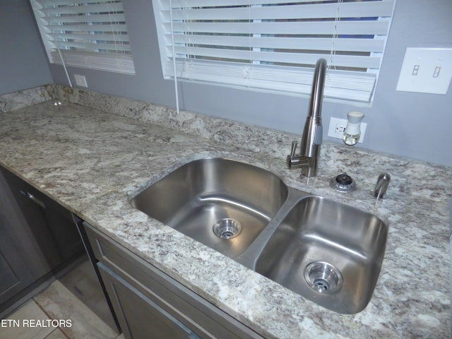 room details with light stone counters and sink