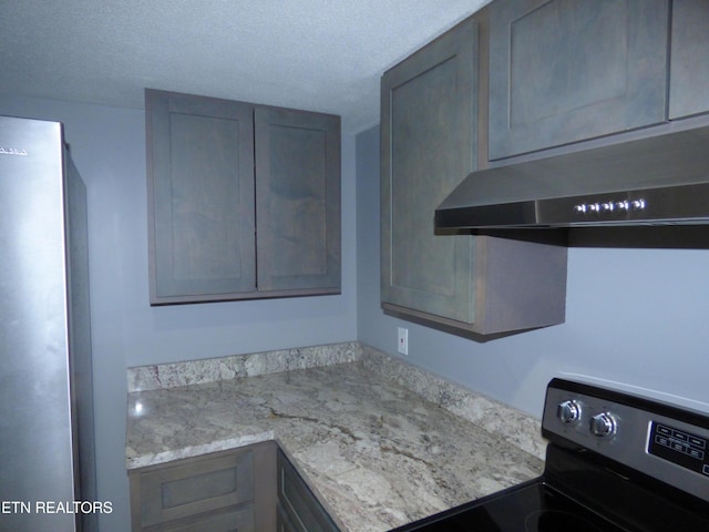 kitchen with stainless steel electric range, gray cabinets, light stone countertops, and a textured ceiling