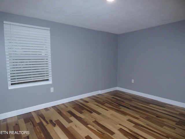 empty room with hardwood / wood-style floors