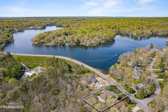 birds eye view of property featuring a view of trees and a water view