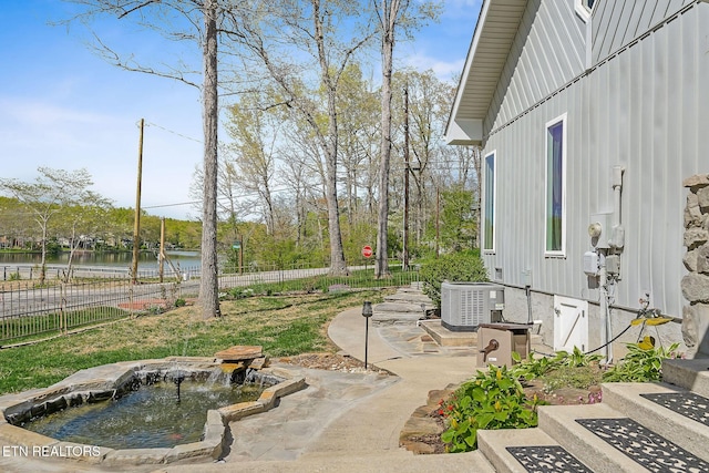 view of yard with a patio area, central AC unit, and fence