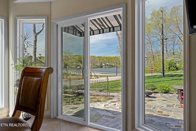 entryway with tile patterned floors and a water view