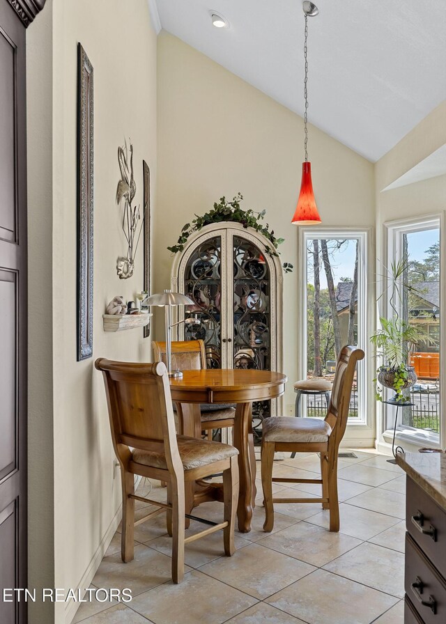 dining area with light tile patterned flooring, french doors, baseboards, and vaulted ceiling