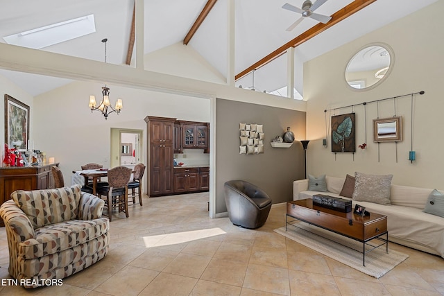 living area featuring beamed ceiling, light tile patterned floors, ceiling fan with notable chandelier, a skylight, and high vaulted ceiling