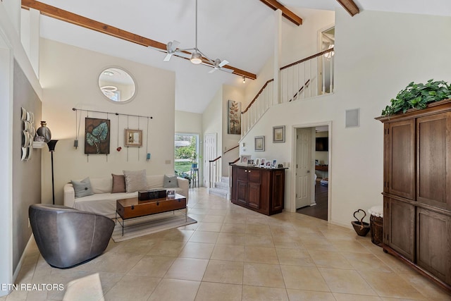 living room featuring beam ceiling, high vaulted ceiling, stairway, light tile patterned floors, and baseboards