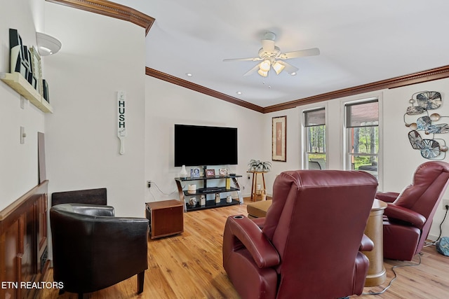 living room featuring crown molding, wood finished floors, and ceiling fan