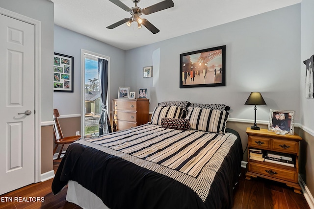 bedroom with a ceiling fan, baseboards, and wood finished floors