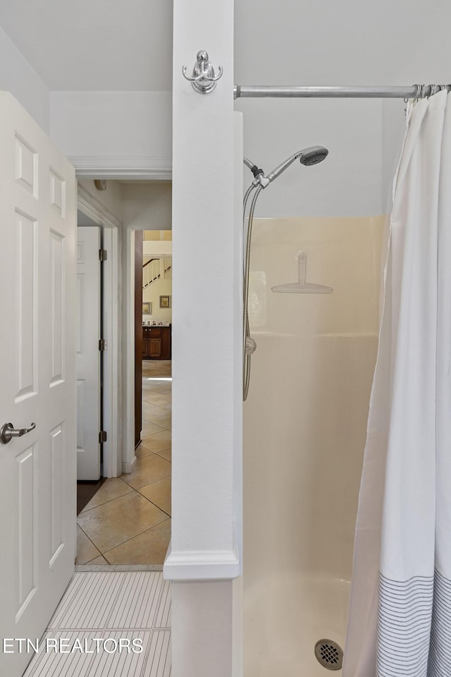 full bathroom with a shower stall and tile patterned flooring