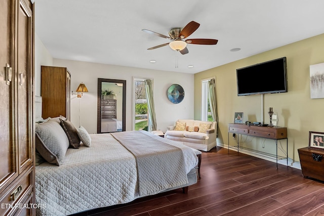 bedroom featuring a ceiling fan, wood finished floors, and baseboards