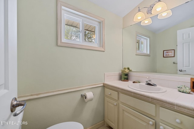 half bathroom with vanity and toilet