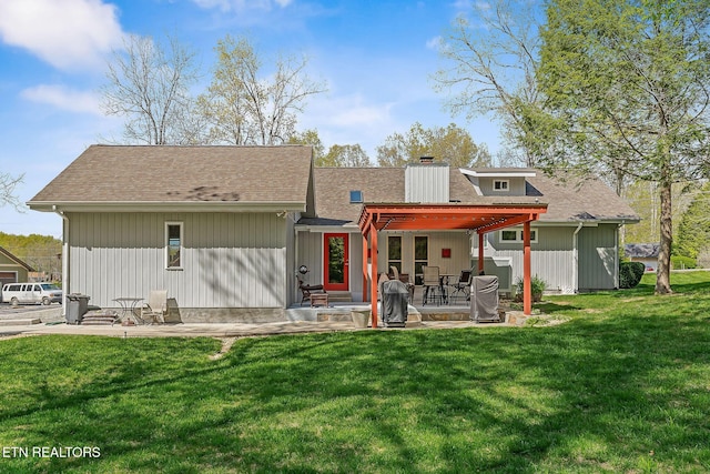 rear view of property with a patio area, a lawn, fence, and a chimney