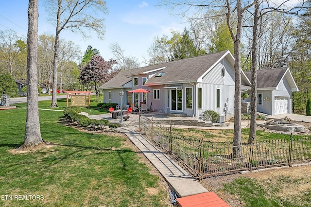 rear view of house featuring a garage, a patio, a lawn, and fence