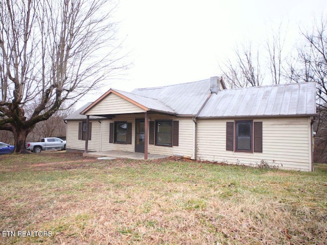 ranch-style house featuring a patio area and a front lawn